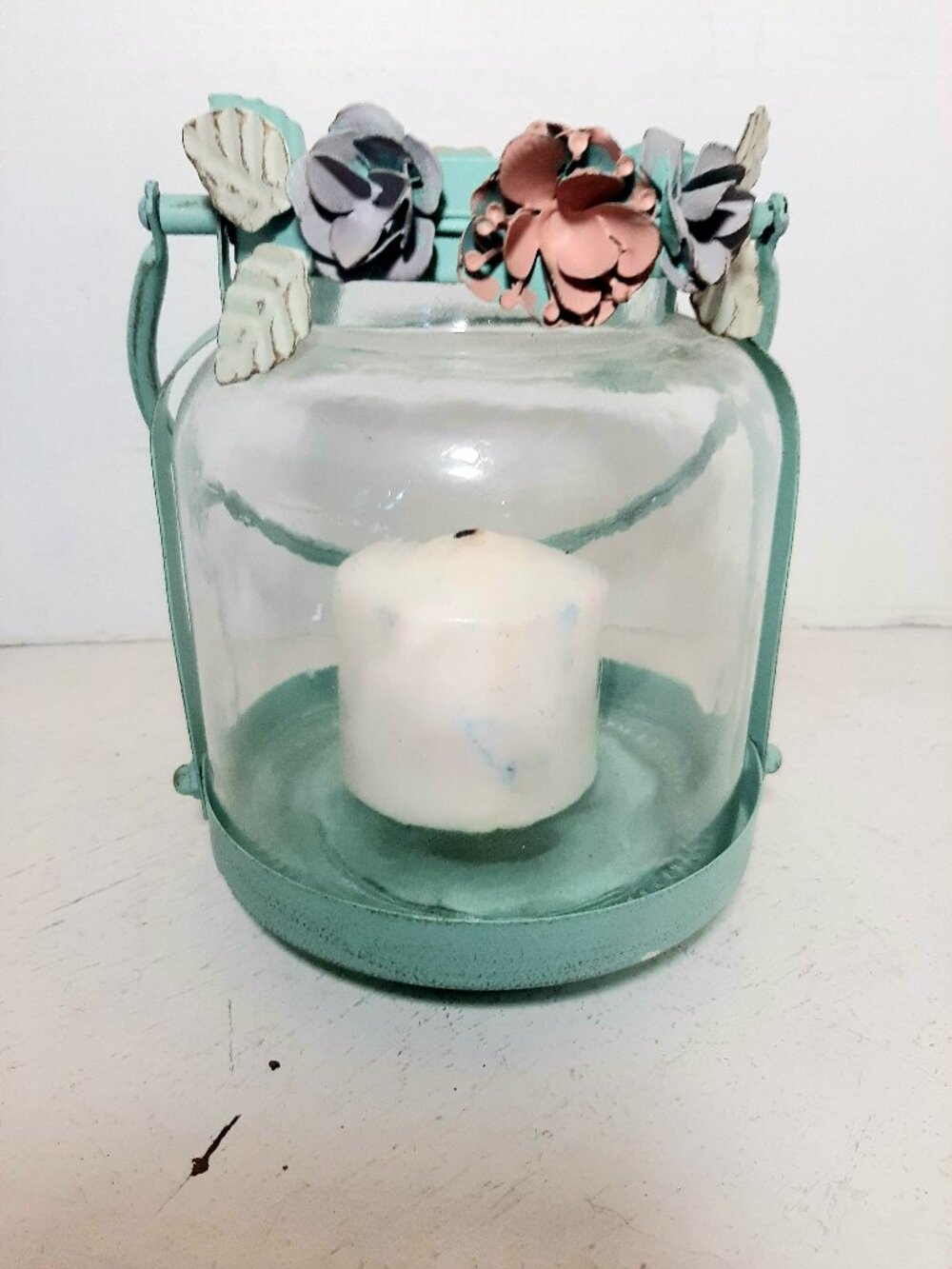 Turquoise metal and glass Pillar Candle Holder with floral accents.